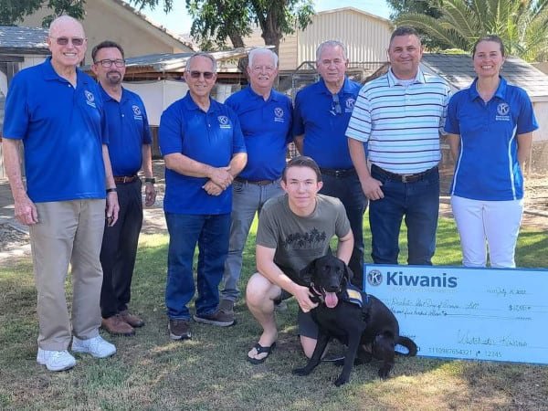 Kiwanis members with Justin and service dog